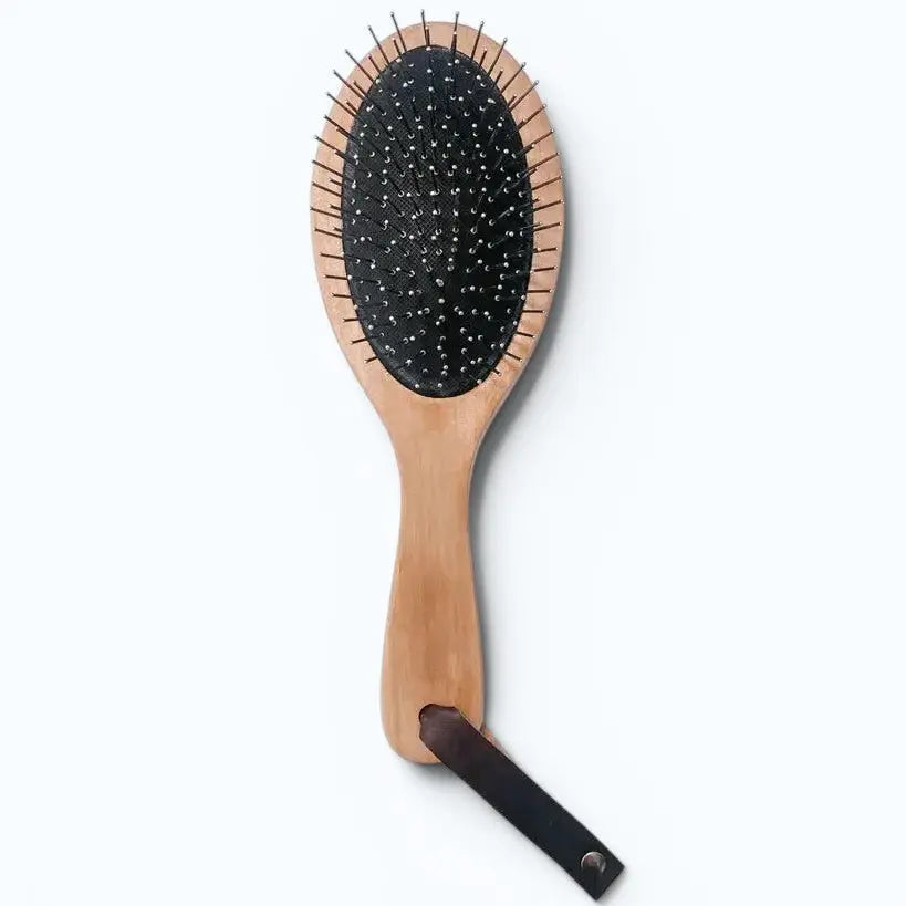 Wooden hairbrush with black bristles on a white background | Hygg