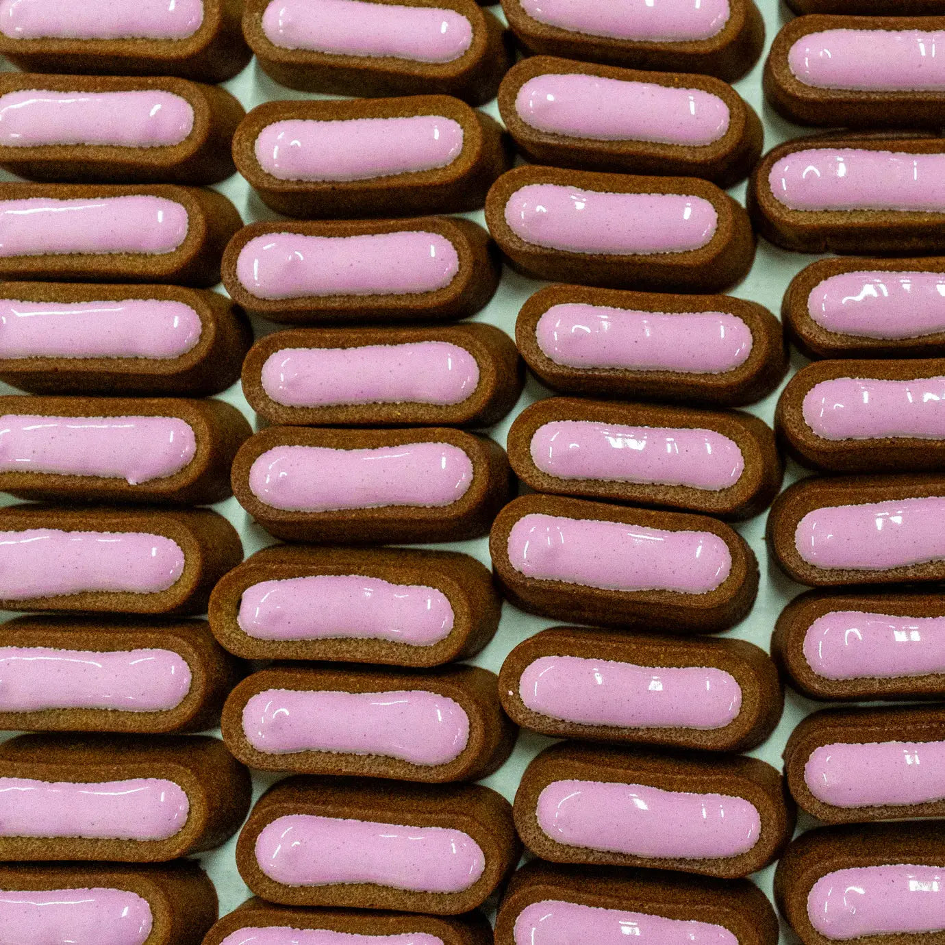 Delamour pastries with pink filling on a light green background