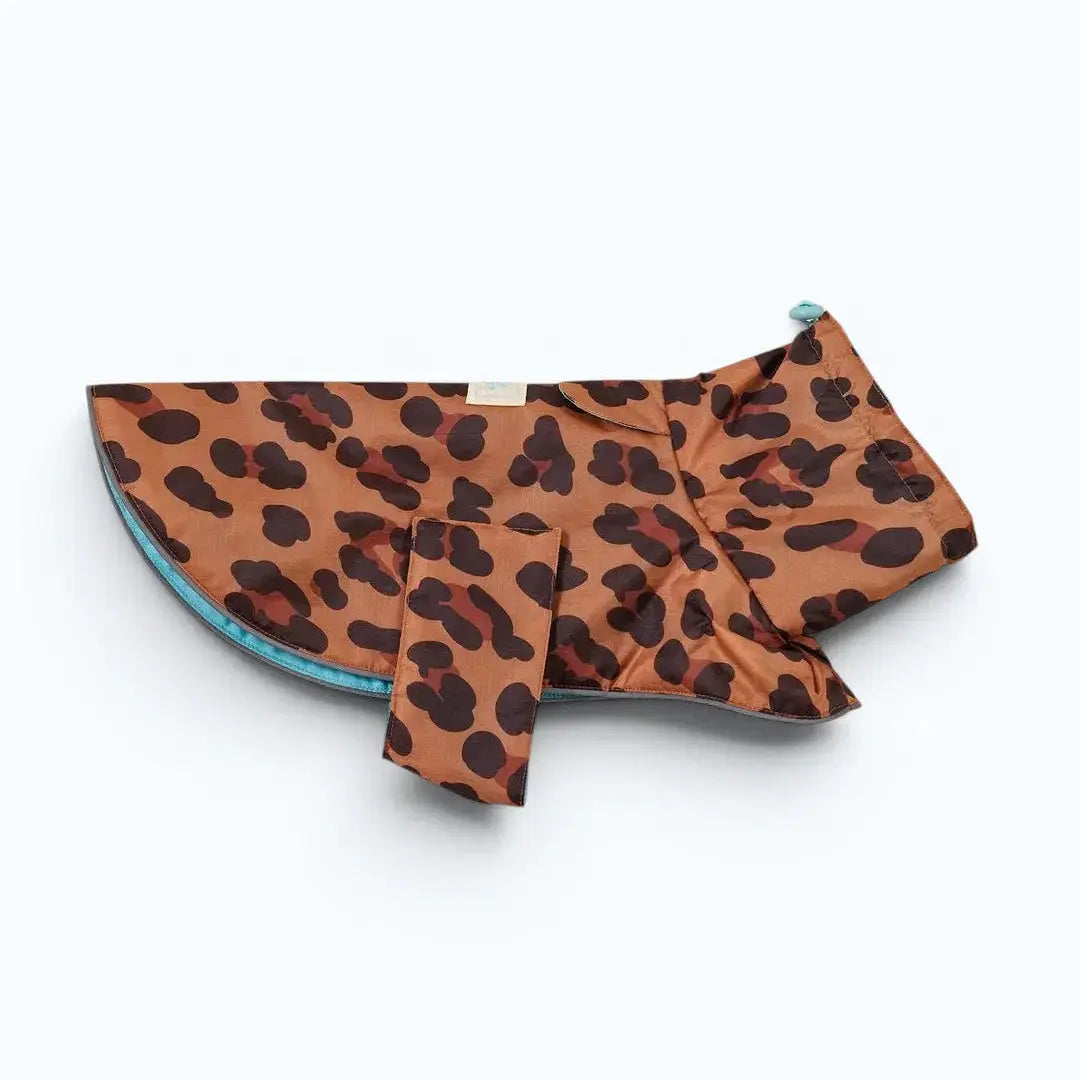 Little Beast Cougar Dog Rain Coat – A lightweight reversible rain coat with bold leopard print exterior and paw-print lining, designed in NYC for dogs