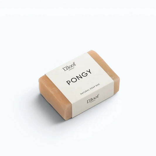 L'floof PONGY Orange & May Chang Dog Soap Bar – soap bar being used on dog coat, lifestyle shot